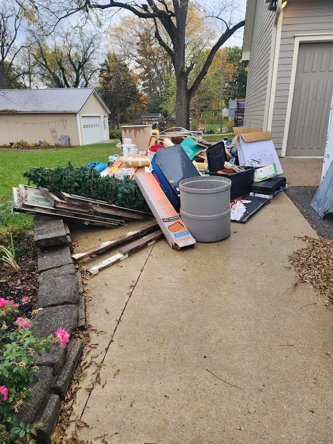 Dumpster being loaded with debris for 12 Yard Dumpster Rental in Cortland